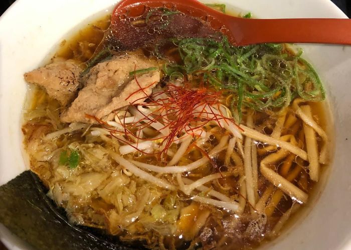 A bowl of vegan ramen from Kyushu Jangara Ramen, featuring noodles, beansprouts, mushrooms, and soy meat.